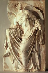 Athena Nike adjusting her sandal